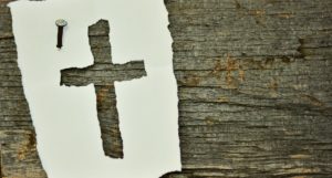 Paper cross nailed to wood beam