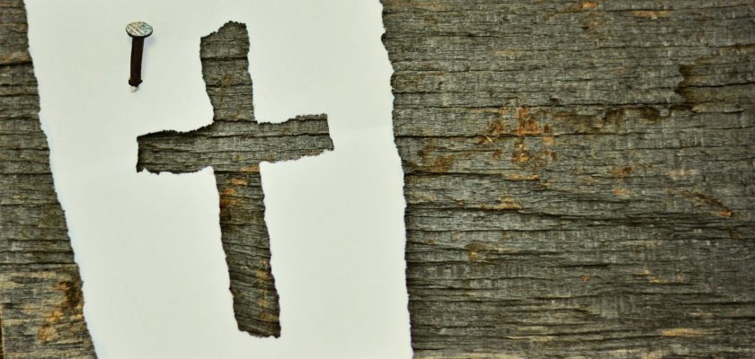 Paper cross nailed to wood beam