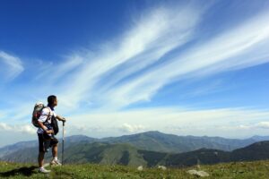 a Figure on a mountain against a blue sky